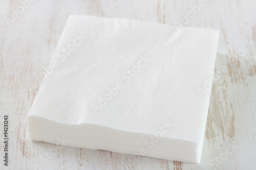 paper napkin on white wooden background photo