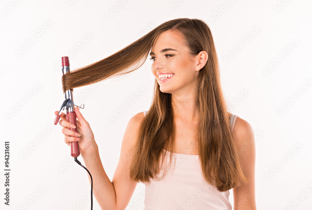 girl with curling. girl twists hair curling on girl with curling. girl twists hair curling on