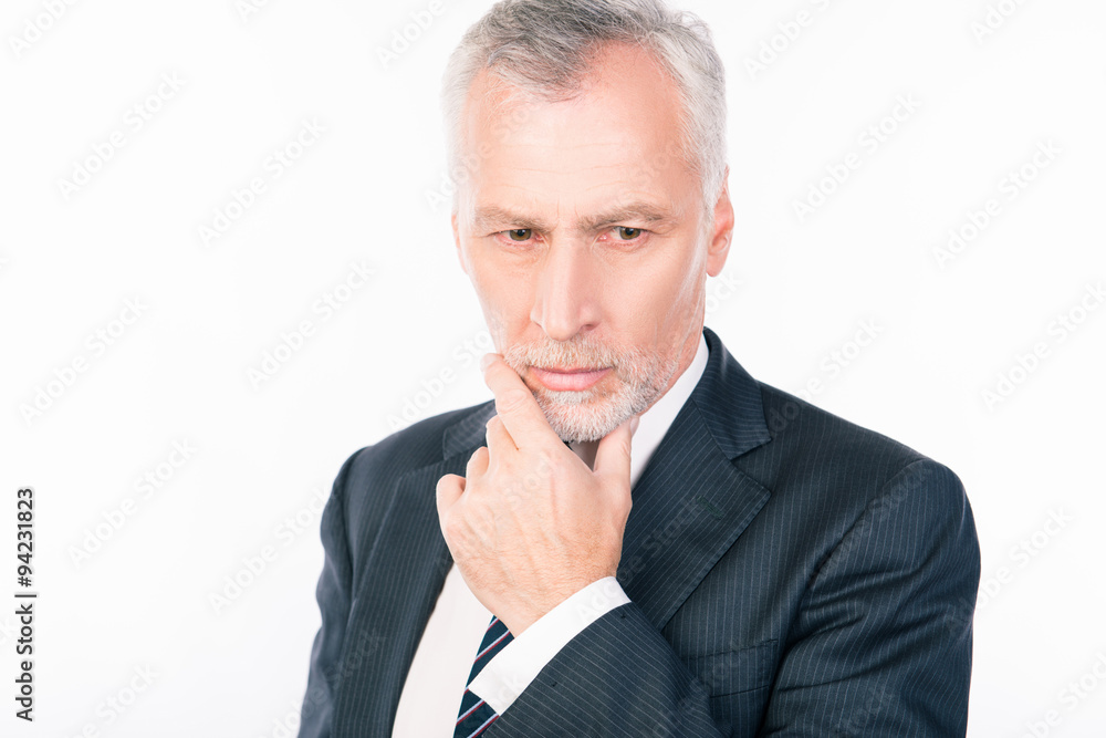 Old intelligent businessman ponders putting his hand on chin Old intelligent businessman ponders putting his hand on chin