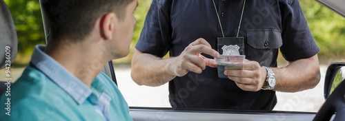 Policeman checking documents photo