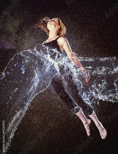 Obraz na plátně Thoughtful Woman in Water Splash Floating in Air