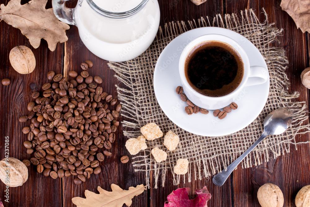 Coffee cup, cream, coffee grains and cane sugar Coffee cup, cream, coffee grains and cane sugar