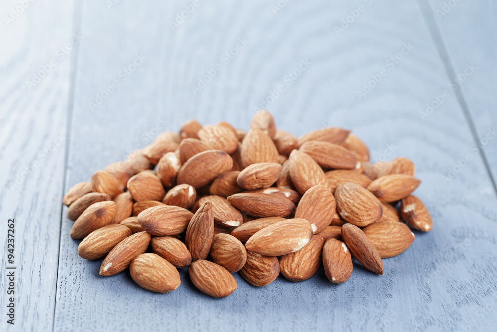 roasted almonds on blue wooden table roasted almonds on blue wooden table