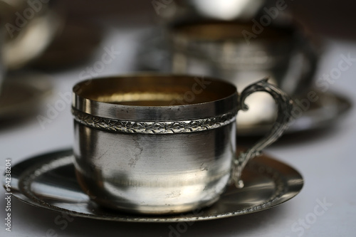 Silver tea cup with saucer