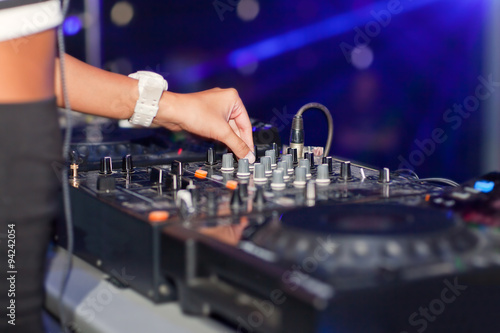 DJ mixing music on console at the night club