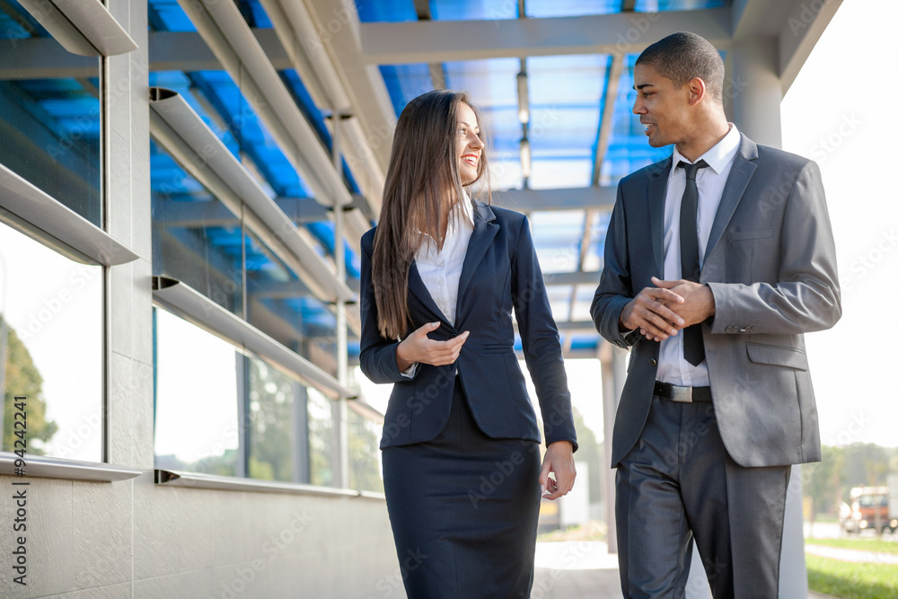 smiling business man and woman on break ,walking around and talk smiling business man and woman on break ,walking around and talk
