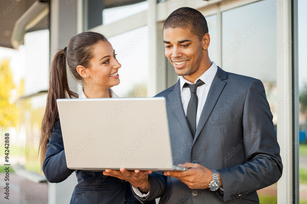 Business man and woman with laptop talking,outdoor Business man and woman with laptop talking,outdoor