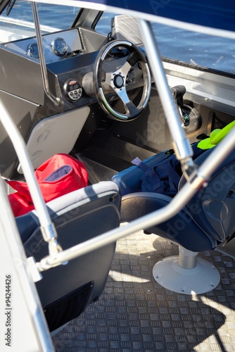 Steering wheel, captain's chair and navigation instruments on boat cabin