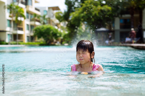 Little girl swim in the pool