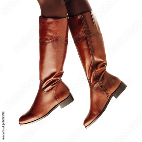 woman legs wearing brown leather high boots