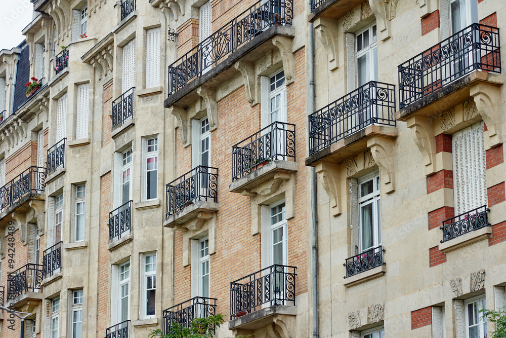 Fragment of the facade of the building with balconies in Reims, France.