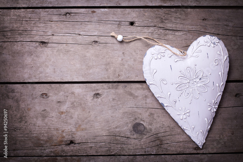 Decorative heart on  vintage wooden  background.