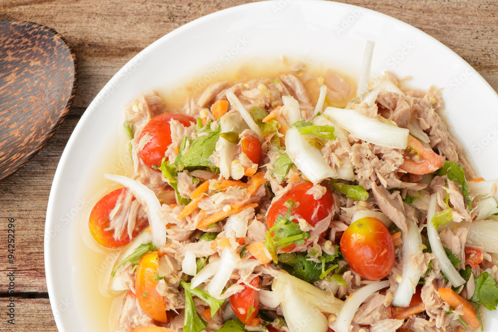 Spicy Tuna Salad onion and tomatoes in plate put on wooden background , Thailand cuisine. Spicy Tuna Salad onion and tomatoes in plate put on wooden background , Thailand cuisine.