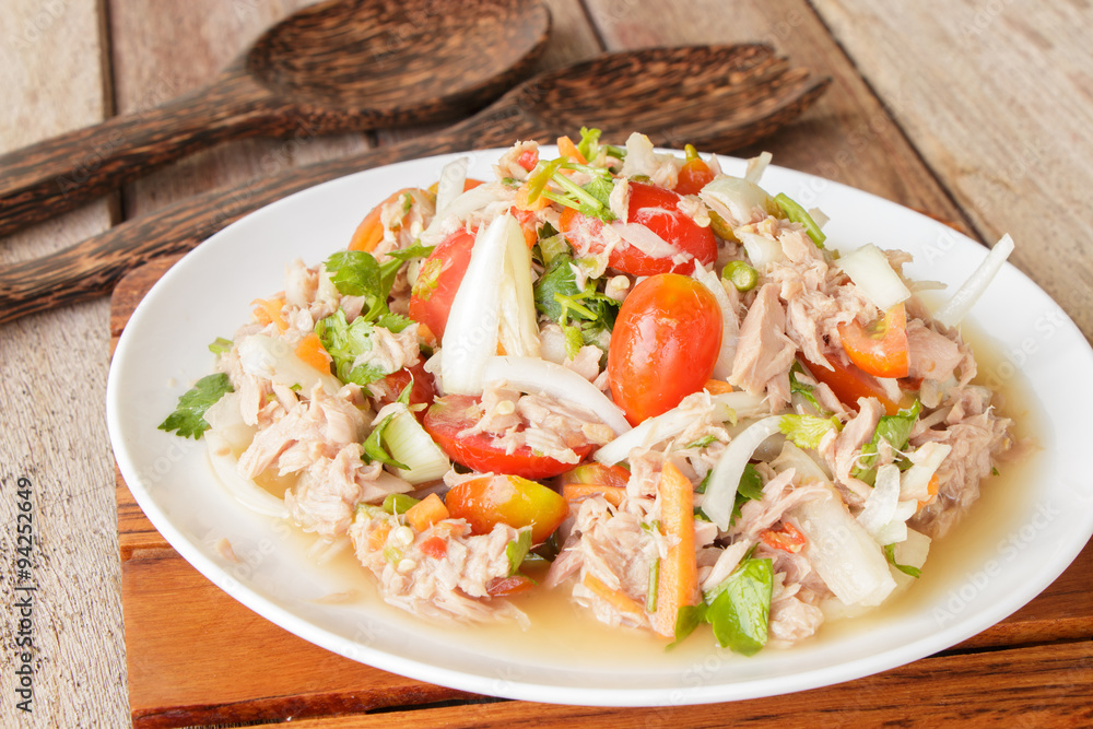 Spicy Tuna Salad onion and tomatoes in plate put on wooden background , Thailand cuisine. Spicy Tuna Salad onion and tomatoes in plate put on wooden background , Thailand cuisine.