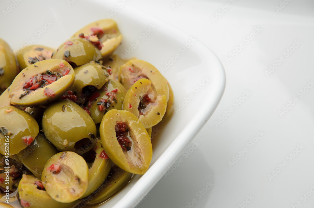 Split olives in white bowl
