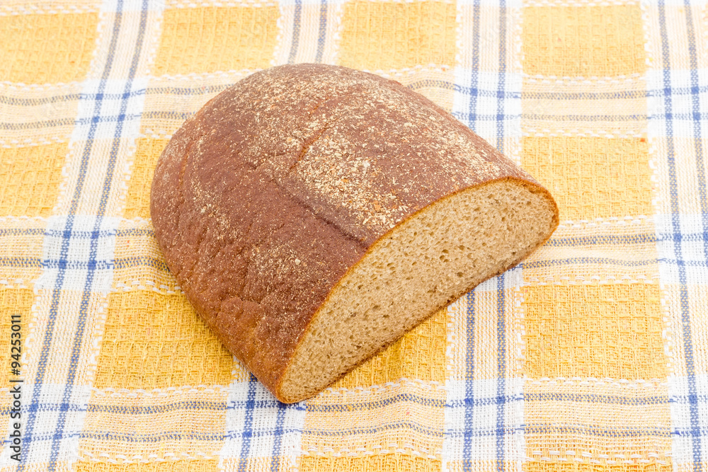 Brown bread on a checkered tablecloth.