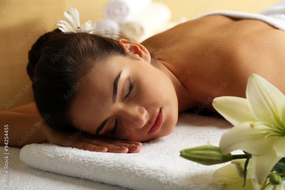 Young woman on massage table in beauty spa salon Young woman on massage table in beauty spa salon