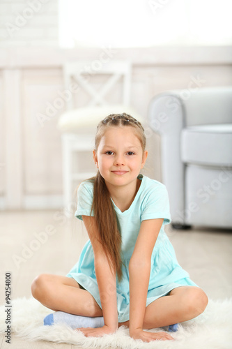Little cute girl sitting on...