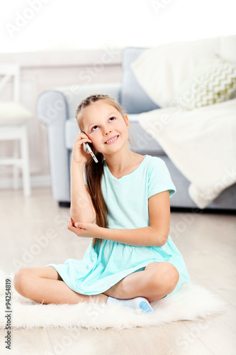 Little cute girl with mobil...