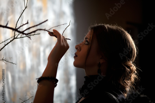 girl holds a hand tree branch