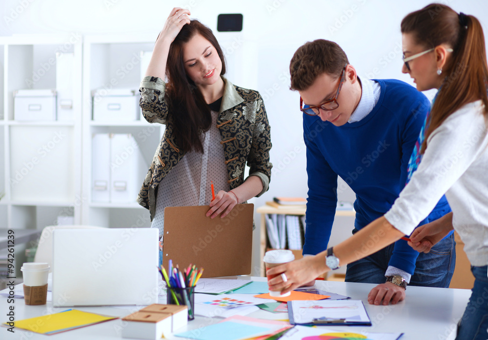 Fototapeta premium Young business people working at office on new project