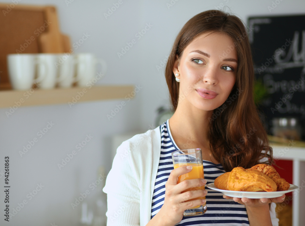 Young woman with glass of juice and cakes Young woman with glass of juice and cakes