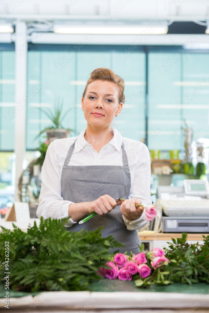 Confident Florist Cutting Stem On Rose In Flower Shop Confident Florist Cutting Stem On Rose In Flower Shop