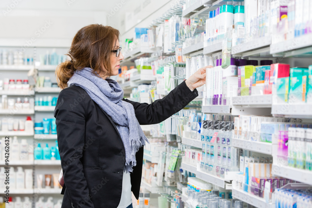 Female Purchaser Choosing Product At Pharmacy Female Purchaser Choosing Product At Pharmacy