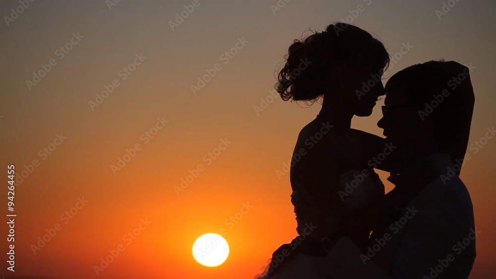 couple embrace on a background of a sunset couple embrace on a background of a sunset