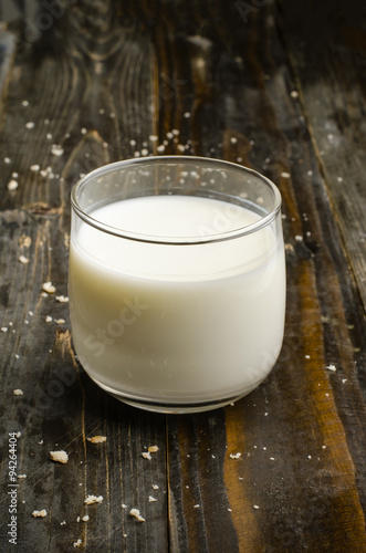 Glass of milk on wooden background