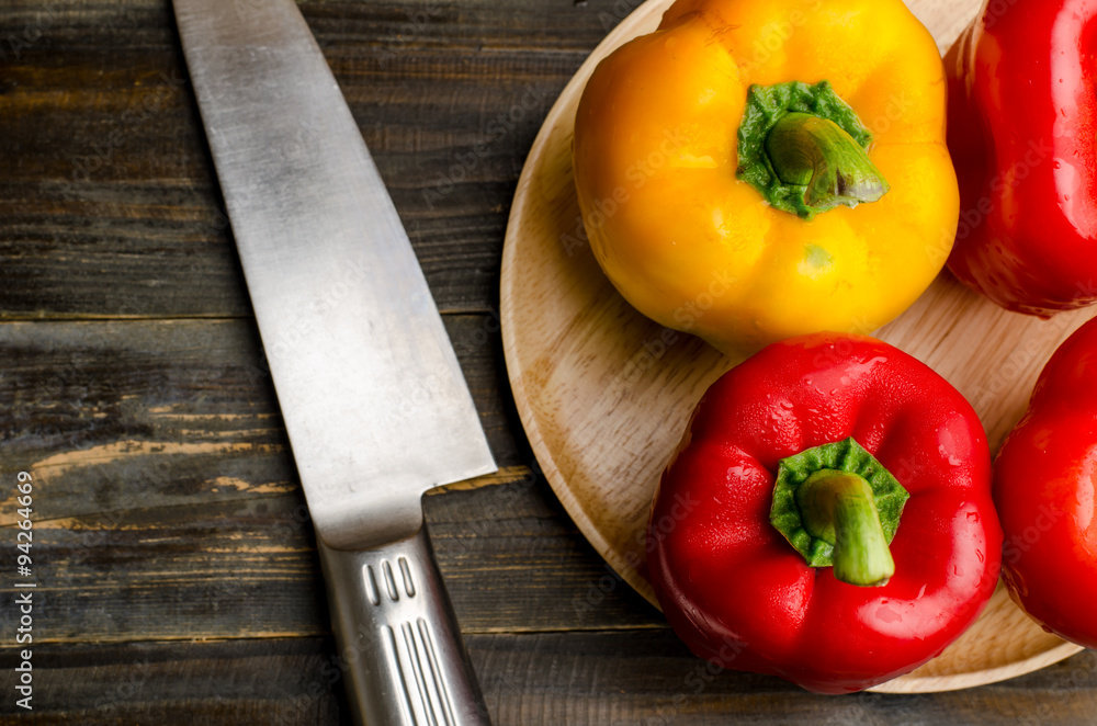 Red and yellow bell pepper or sweet pepper ready for cooking on wooden background Red and yellow bell pepper or sweet pepper ready for cooking on wooden background