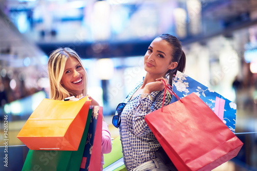 happy young girls in shopping mall