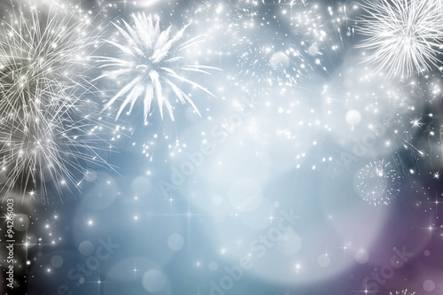 Abstract holiday background with fireworks and sparkling lights