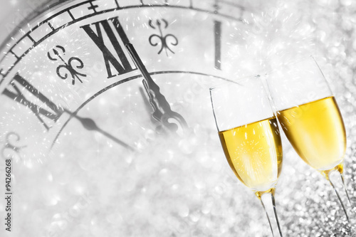 Champagne over fireworks and clock close to midnight