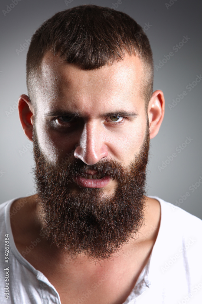 Obraz premium Portrait of handsome bearded man standing, isolated on grey