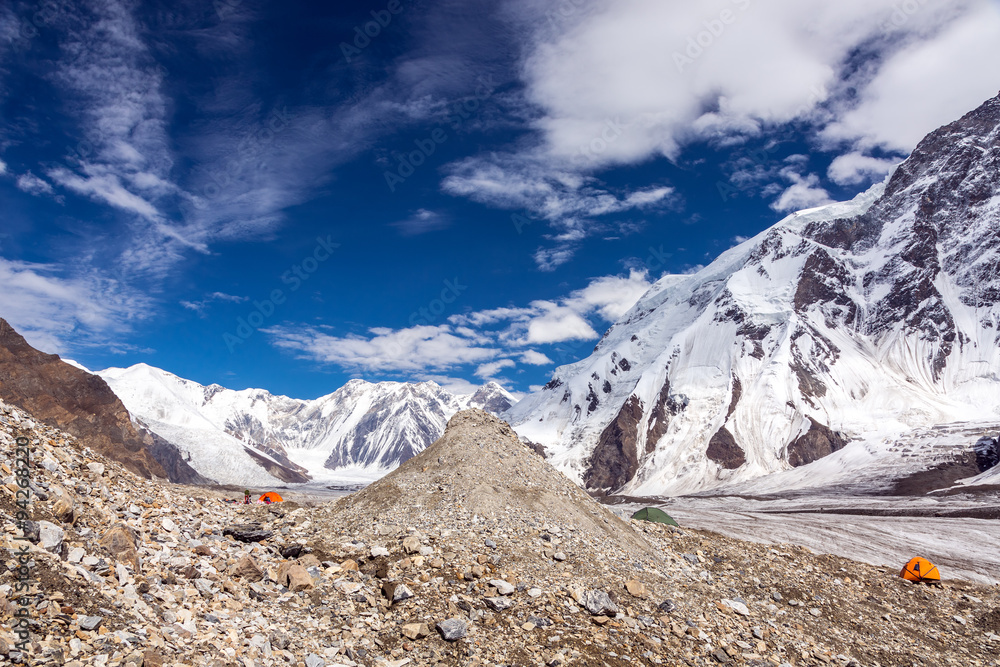 High Mountains Panorama with Red and Orange Tents on Glacier Moraine