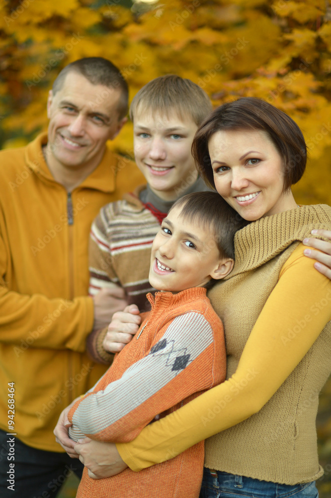 Family relaxing in autumn park