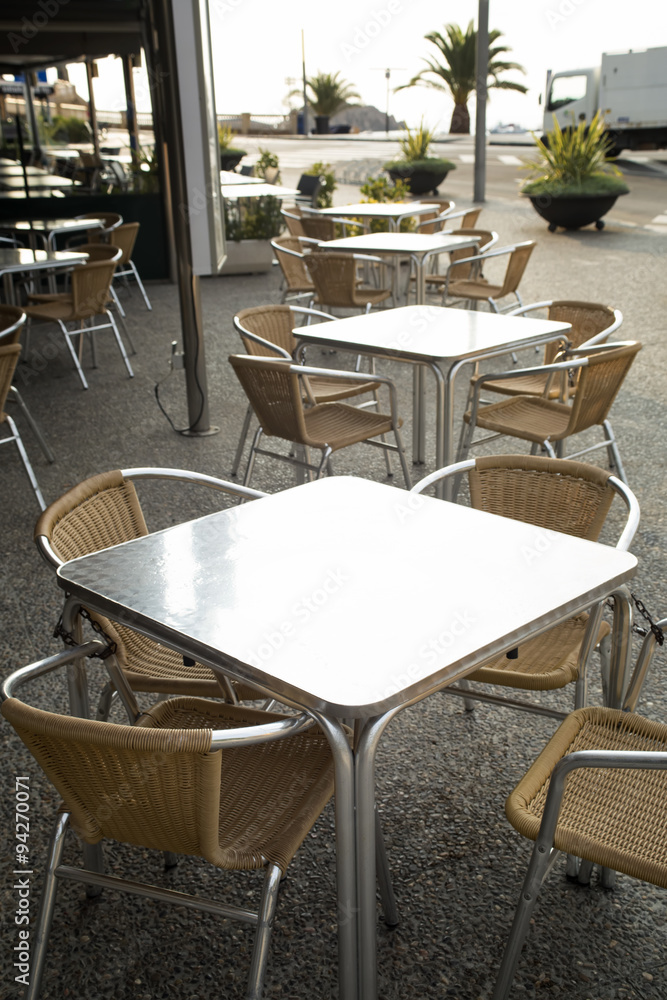 Metal rattan tables and chairs outdoor of restaurant.
