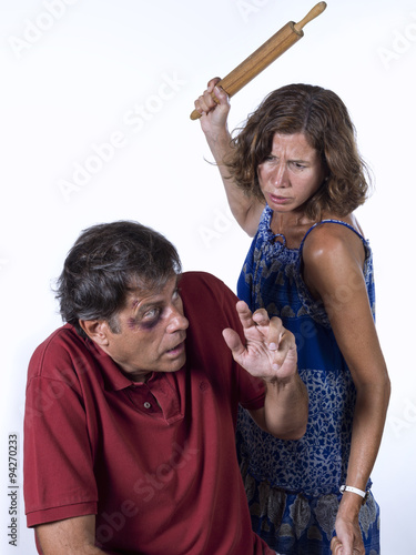 woman with a rolling pin, beating her husband
