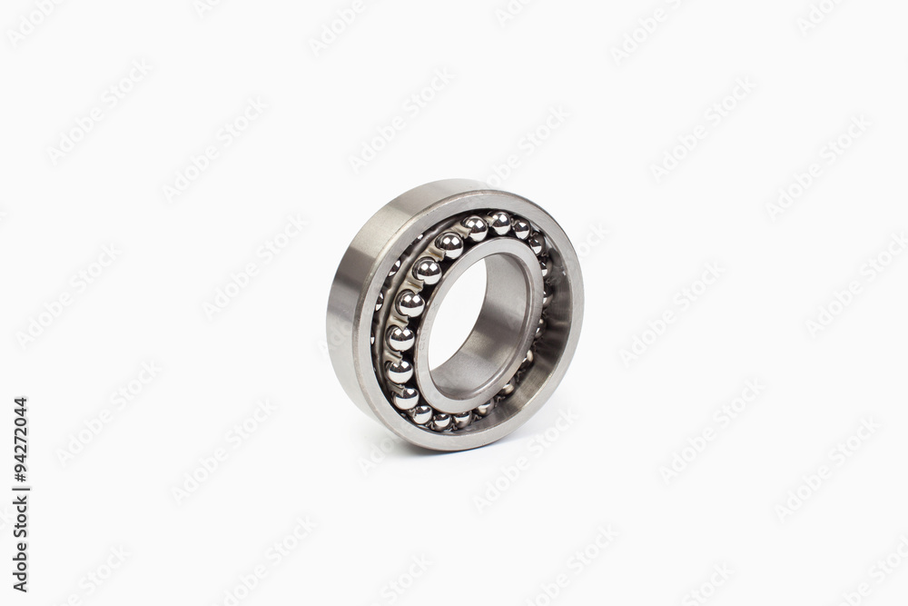 Close-up bearings spare part of mechanical on the white background. Close-up bearings spare part of mechanical on the white background.