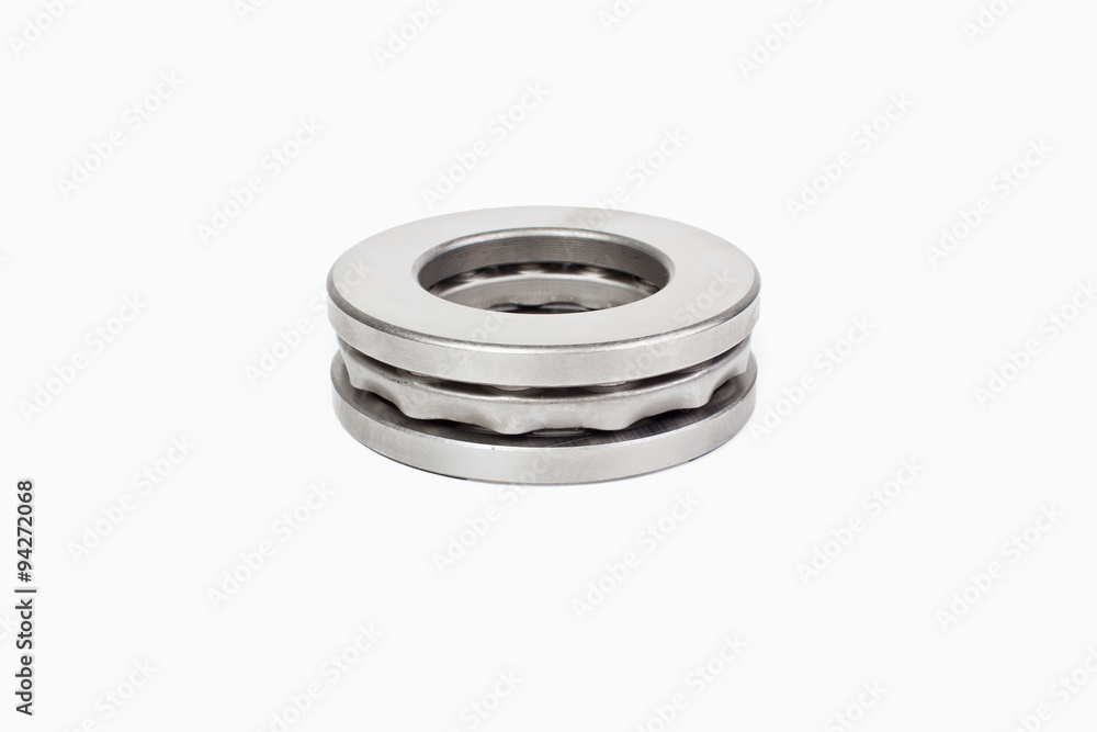 Close-up bearings spare part of mechanical on the white background. Close-up bearings spare part of mechanical on the white background.