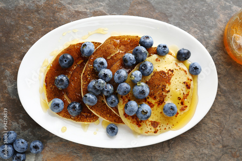 hot golden pancakes with berry on plate