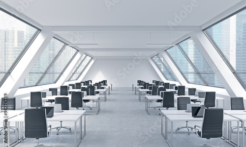 Workplaces in a bright modern open space loft office. White tables equipped by modern laptops and black chairs. Singapore panoramic view in the windows. 3D rendering.