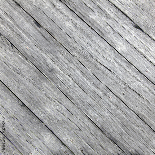 square picture of old rough gray wooden planks diagonally placed