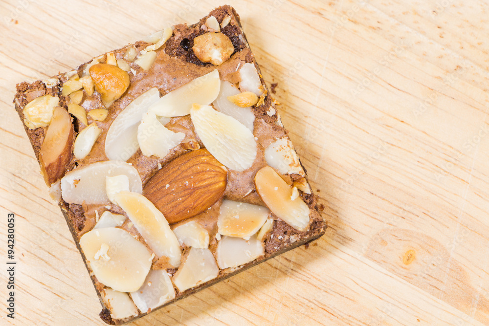 Homemade brownies sliced and topping on wooden background Homemade brownies sliced and topping on wooden background