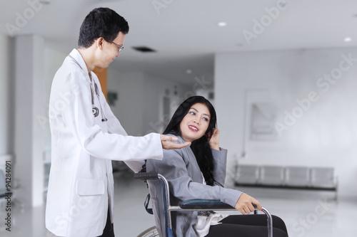 Doctor talking with patient in the hospital corridor