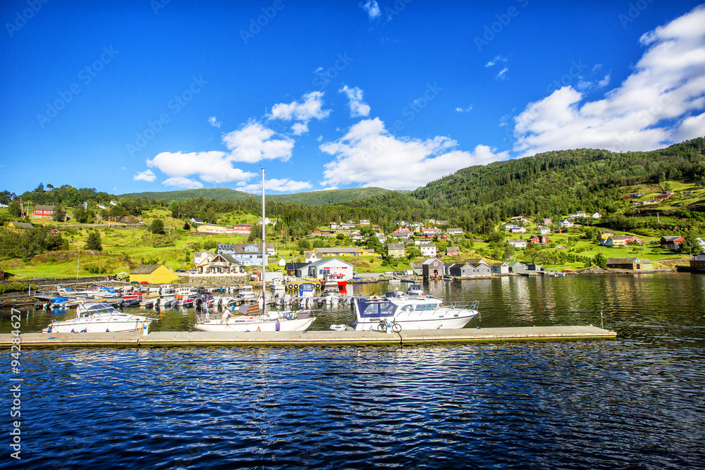 Meadows and village on Hardanger Fiord. Norway shore with view.  Norway.