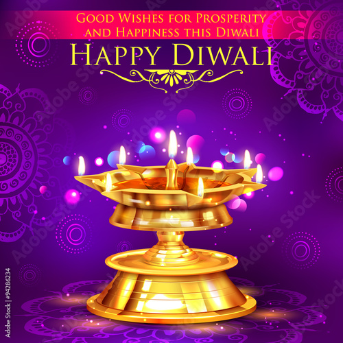Golden diya stand on abstract Diwali background