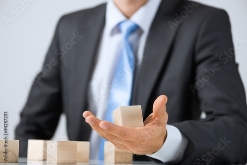 Businessman making tower