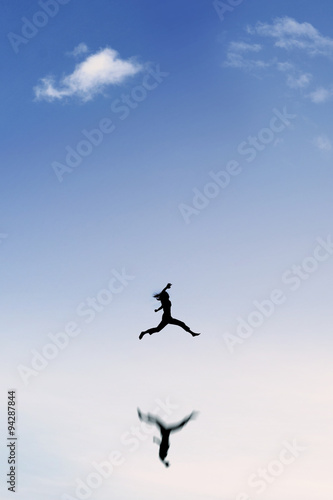 Woman enjoy vacation and jumps on the sky